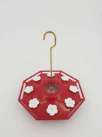 Red saucer hummingbird feeder with flower ports