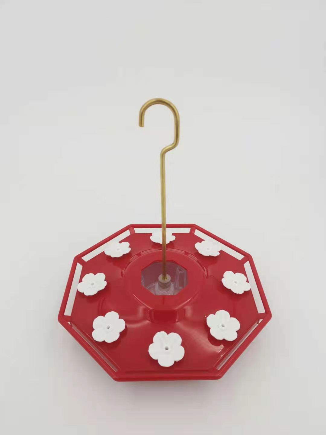 Red saucer hummingbird feeder with flower ports